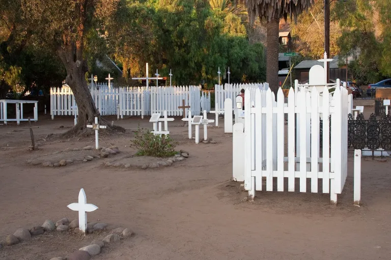 White picket fences and wooden crosses at El Campo Santo cemetery in Old Town