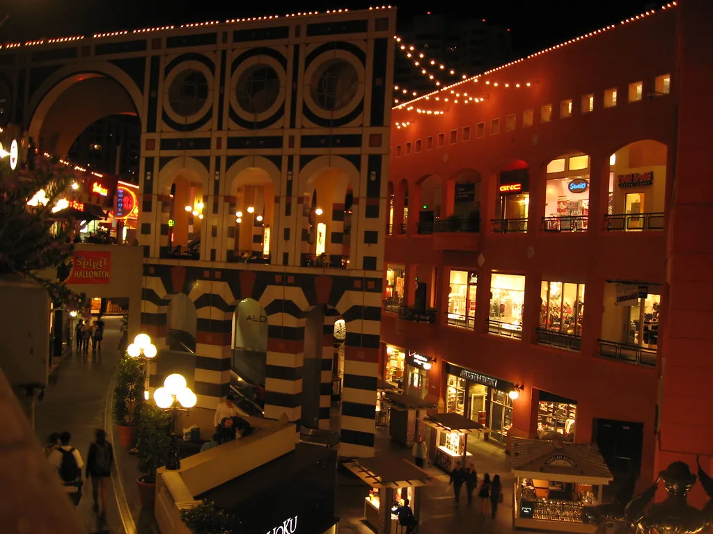 Colorful lit-up shops and string lights at night at the edge of the Gaslamp Quarter in downtown San Diego
