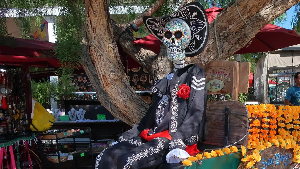 A Día de los Muertos skeleton in a sombrero among marigolds in Old Town San Diego